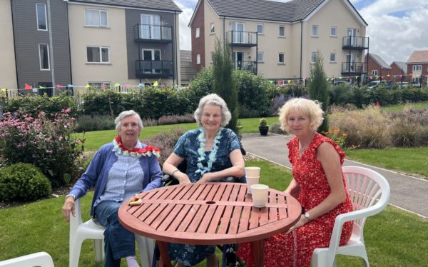 osm summer fete, 3 ladies sat in the garden posing for a picture