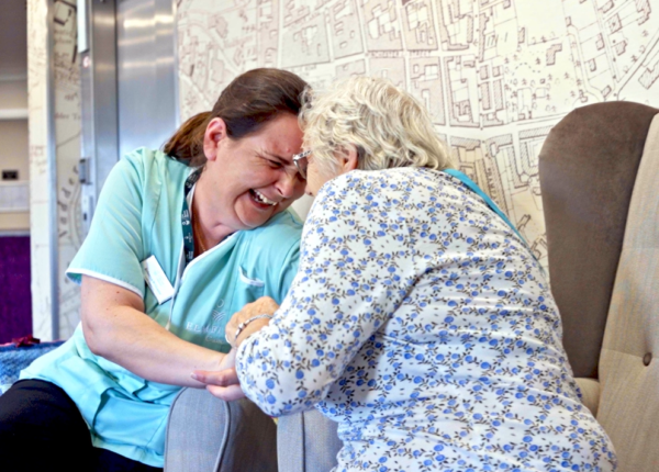 care assistant and resident laughing